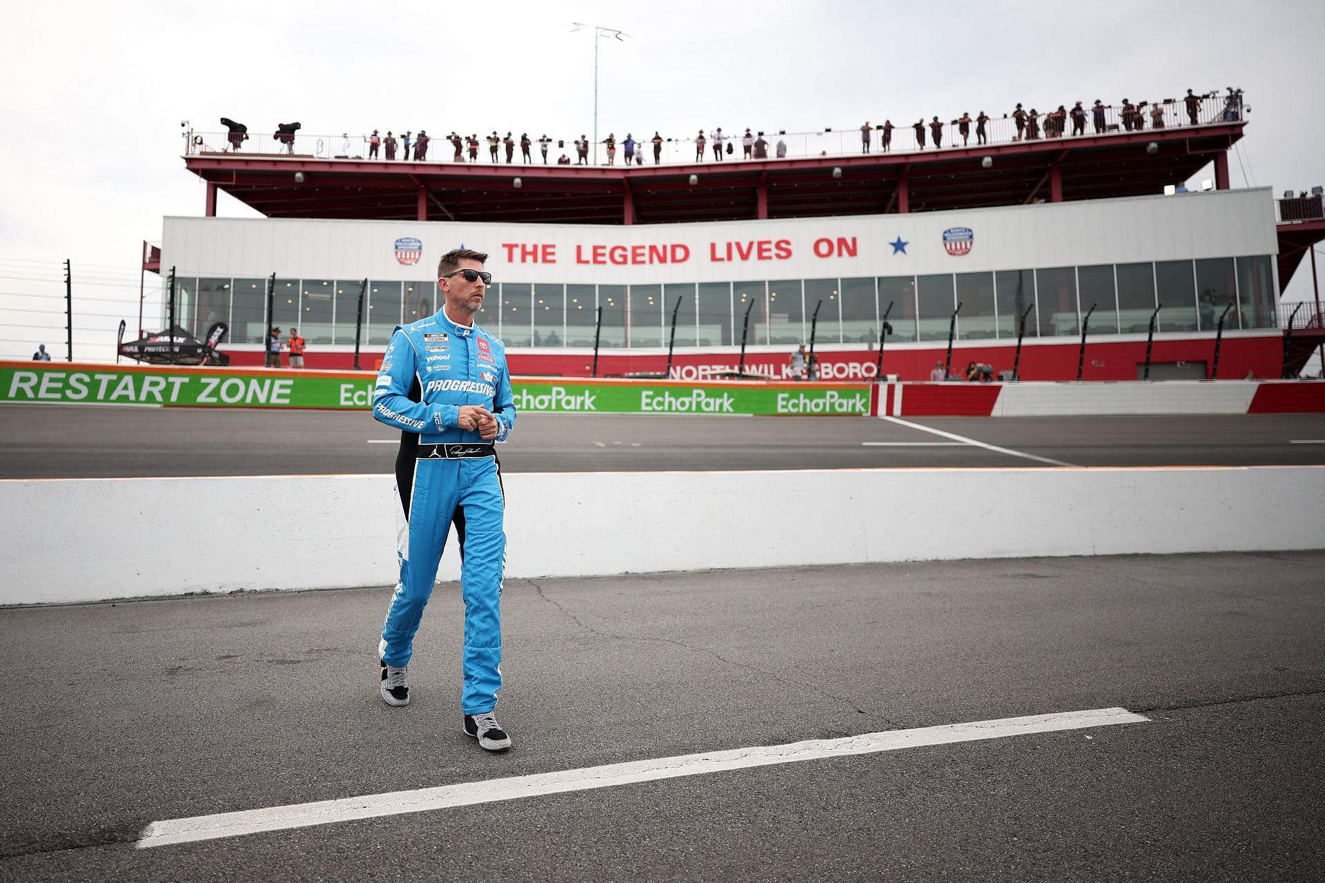 Denny Hamlin walks the grid during the NASCAR Cup Series All-Star Pit Road Qualifying. Source: Getty